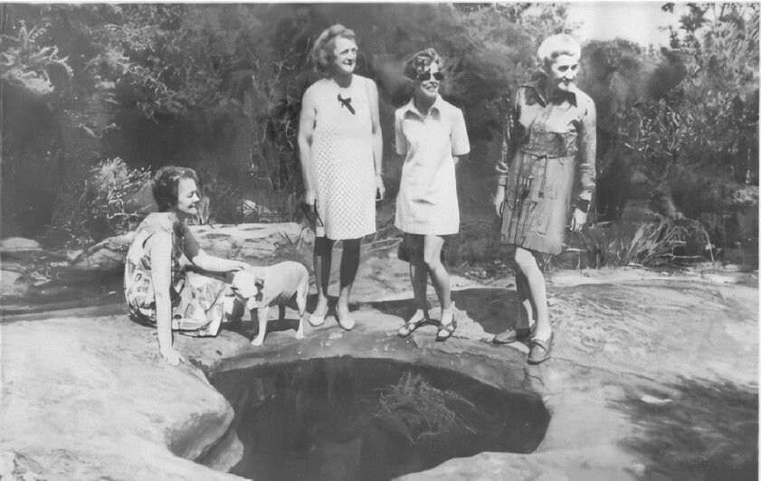 “The Battlers” standing next to Aboriginal Rock Pool: An essential freshwater source.